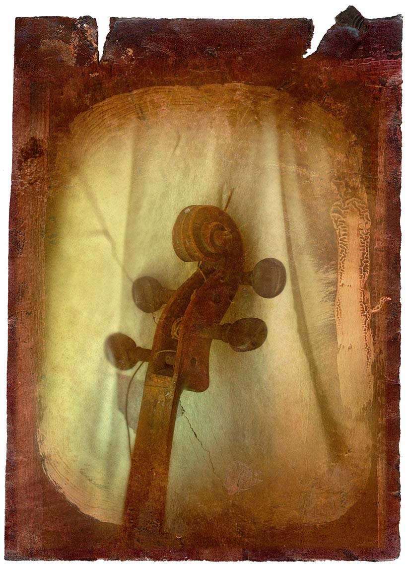 Old violin headstock with broken strings against a mottled sepia colored background.