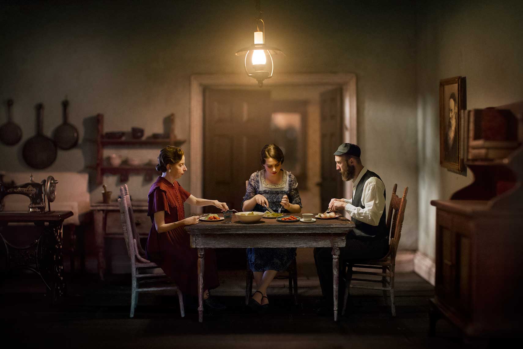 An homage to Van Gogh’s “The Potato Eaters”, a painterly photomontage of 1930s Eastern European Jewish family eating a humble meal of cabbage and potatoesl in 1930s’ apartment in the dim light of a kerosene lantern chandelier.