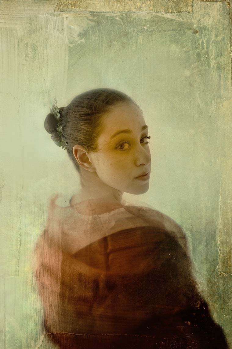 Portrait of a pretty young woman with brown hair tied back in a red shawl against a teal background with an antique, painterly patina.